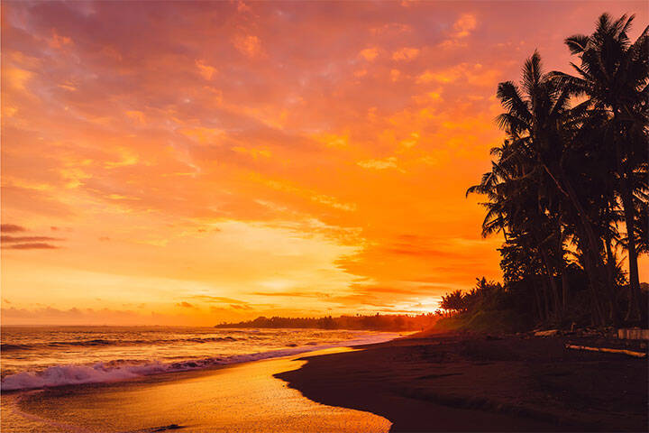 Vibrant sunset and coconut trees on Keramas beach, Bali, 