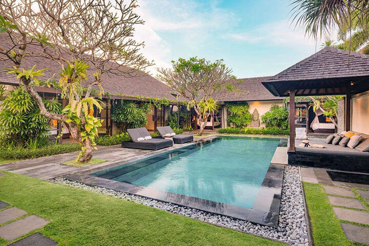 Outdoor swimming pool and lounge area in villa at Peppers Seminyak