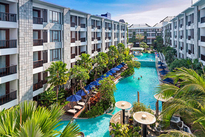 Aerial view of hotel rooms overlooking swimming pool at Courtyard by Marriott Bali Seminyak Resort 