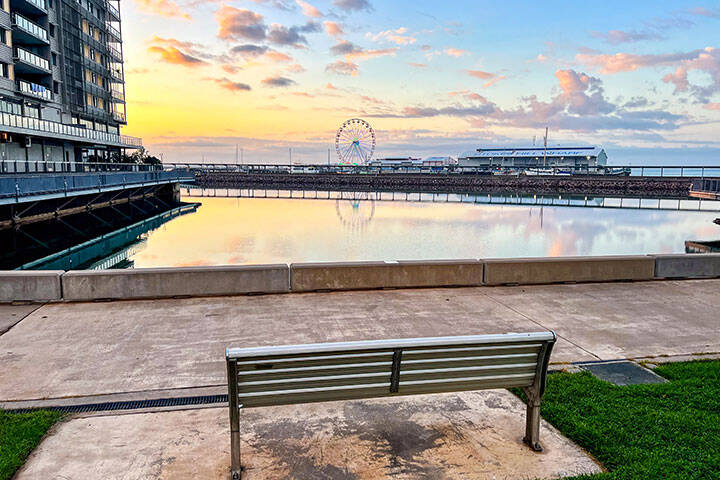 Empty Bench by Darwin Waterfront and Stokes Hill Wharf at sunrise, Darwin, Northern Territory, Australia