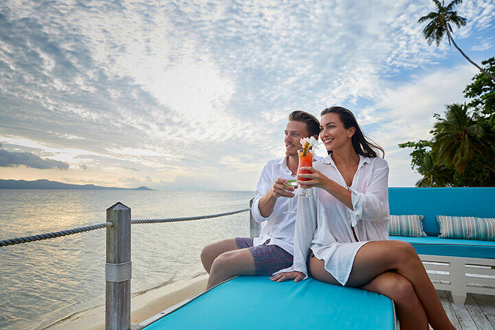 Couple enjoying sunset drinks in Fiji