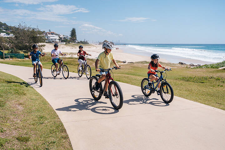 Tugun Beach - Family cycling along the beachfront pathway
