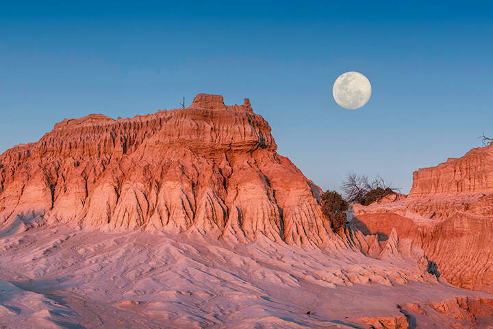 Moon rising over the Walls of China in World Heritage Mungo National Park. 