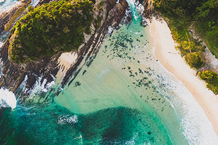 Aerial overlooking the scenic waters off Number One Beach, Seal Rocks