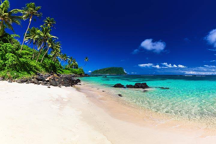 Blue water and white sand on Lalomanu beach, Samoa