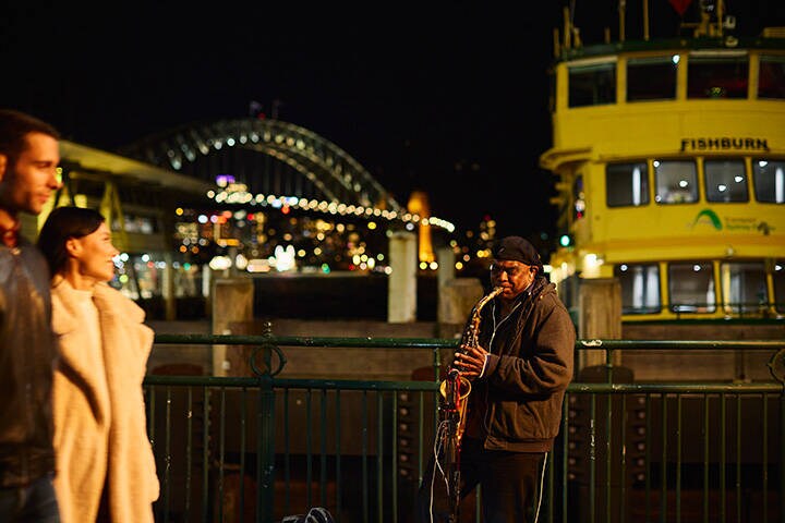 Busker performing in the evening at Circular Quay, Sydney. 