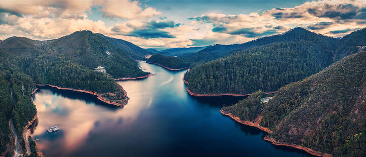 Aerial view of lake and surrounding forest in Tasmania