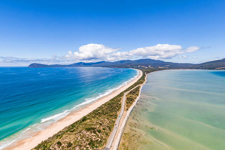 High angle aerial drone view of the Neck, an isthmus of land connecting north and south Bruny Island in southern Tasmania, Australia that offers 360 degree views and is a famous tourist destination.