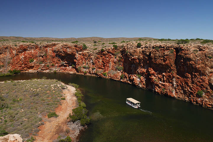 View of Yardie Creek Gorge with a tourist boat. Cape Range National Park in Western Australia, Australia 