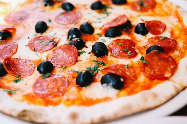 A freshly served Capricciosa pizza from the wood-fired oven at Via Napoli Sydney, featuring vibrant toppings and a golden crust.