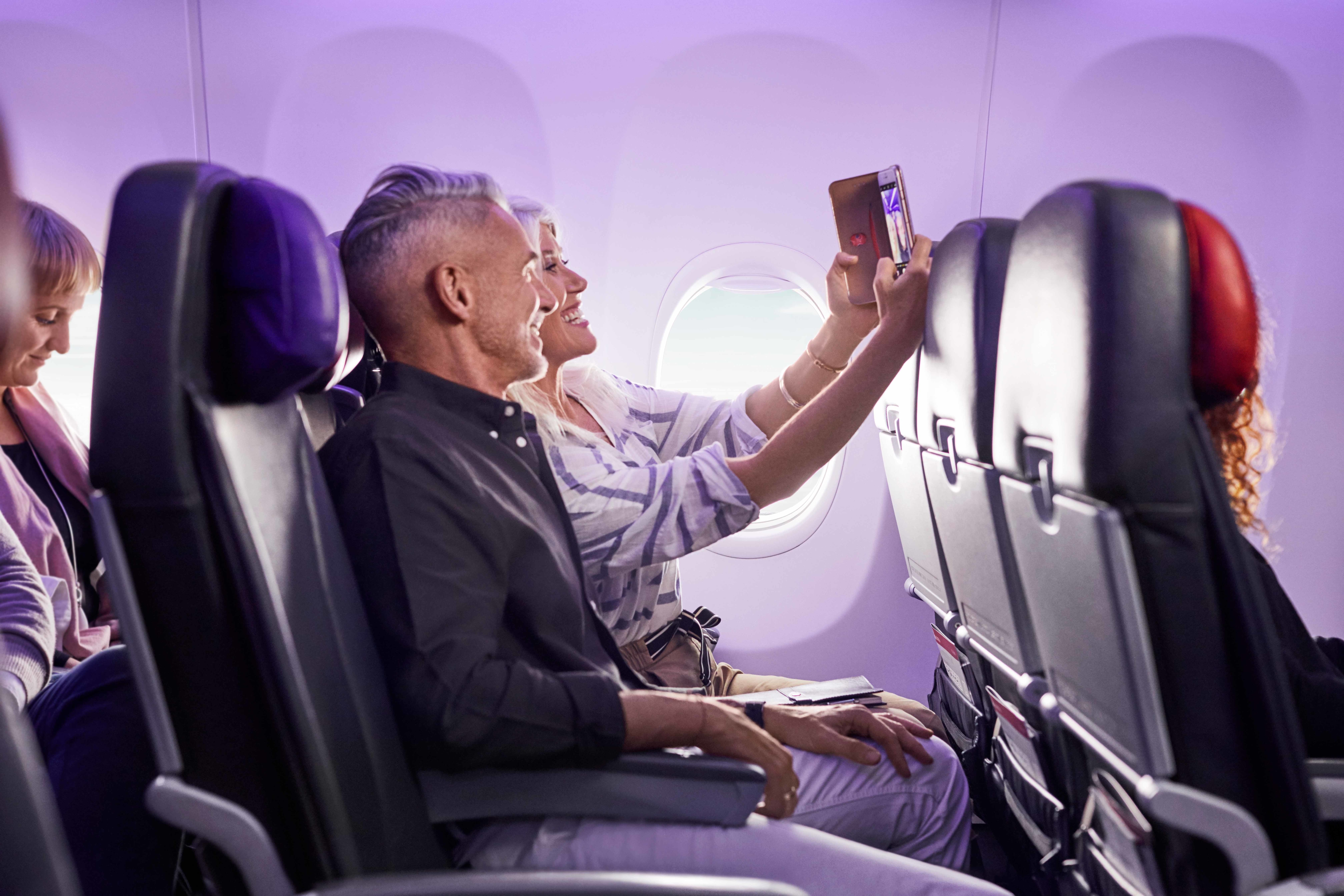 Couple seated comfortably in Economy X seating on Virgin Australia flight