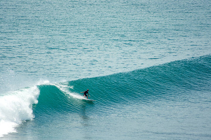 Lone surfer at impossibles, Bali