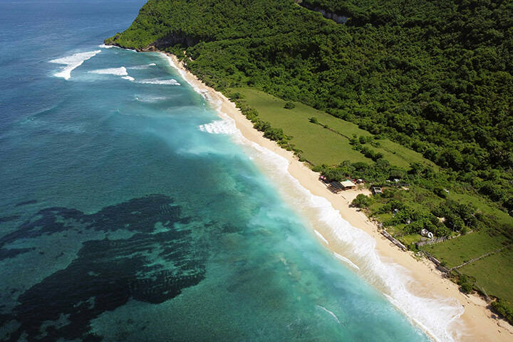 an aerial view of Nyang Nyang beach and a forested area 