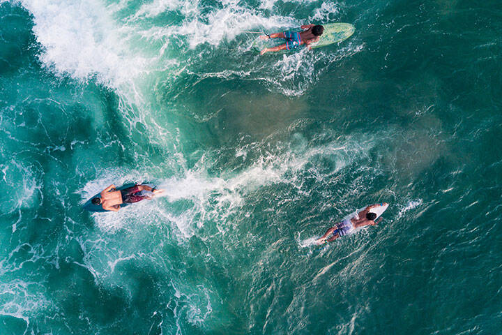 Aerial view of people surfing in Bali