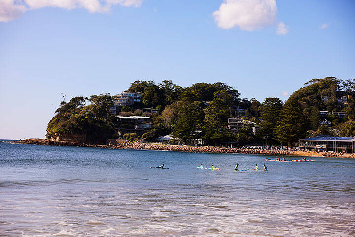 Swimmers and surfers enjoying the water at Avoca Beach