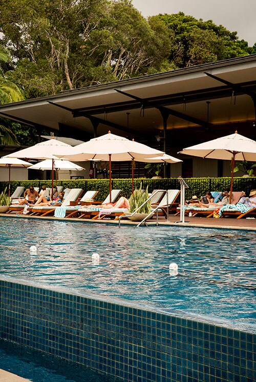 People relaxing by the pool at Crystalbrook Byron, Byron Bay. Credit: Destination NSW