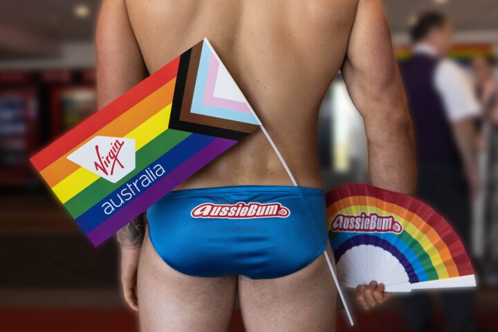 Back of mans speedos with pride flags displayed before Virgin Australia Pride Flight